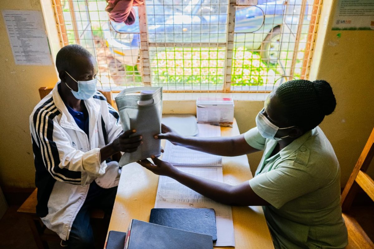 A health worker and a patient at a primary healthcare facility